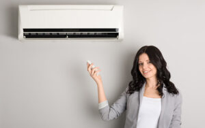 Woman Holding Remote For Ductless System